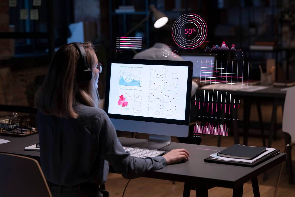 Fusion Practices Whitepaper Featured Image - AI Reporting - Woman using her computer at work